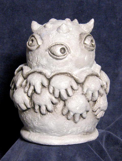 This is the sacred and mysterious Dalp of Annacrabb, beloved and fearsome idol of the Cantaloupe People. I created this sculpture or maquette (to use a fancy term) of the Dalp and the wondrous production designer, Anthony Tremblay, sculpted the lovely gilded Dalp based on this maquette, that you see in the film.