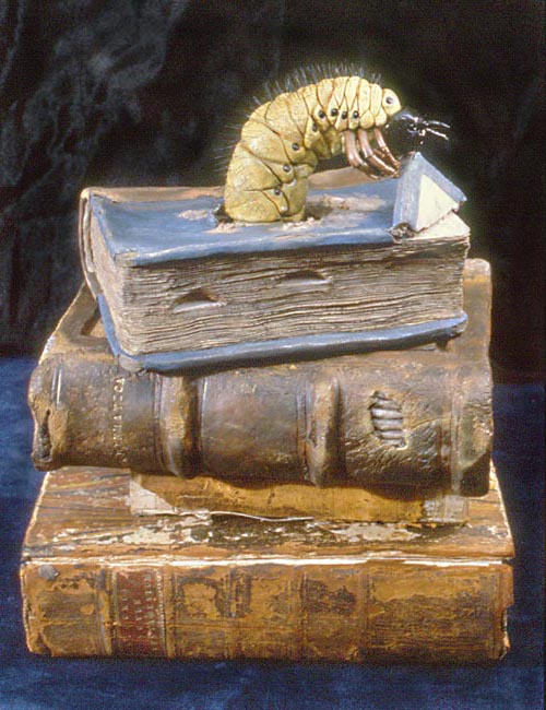 Bookworm
I found a terrific photo of a cellulose-eating worm discovered in an antique piano, and wanted to sculpt a jumbo sized version, but then needed a context for him. The name of the sculpture and his context both occurred to me at the same time. The only real book in this photo is the bottom one, a 1731 Latin Old Testament. The other books are sculptures.